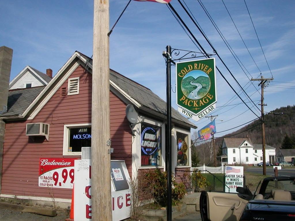 The Cold River Package storefront — a small red clapboard building with a hand-painted Wine Cellar sign